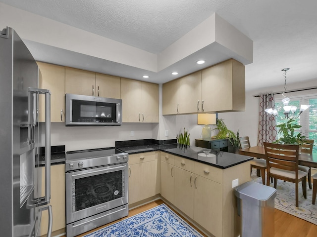 1235 Shagbark Rd, Columbus, OH 43230 - kitchen featuring appliances with stainless steel finishes, light wood-type flooring, recessed lighting, a peninsula, and pendant lighting