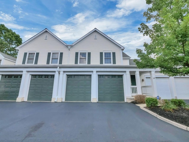 1235 Shagbark Rd, Columbus, OH 43230 - view of front facade featuring asphalt driveway and a garage