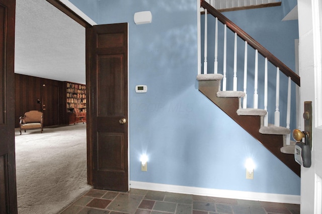 2399 Arabelle Dr NE, Lancaster, OH 43130 - staircase with carpet flooring, stone finish floors, and wood walls