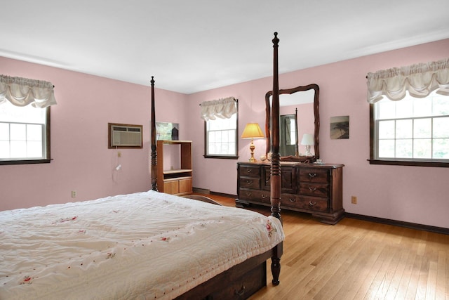 2399 Arabelle Dr NE, Lancaster, OH 43130 - bedroom with a wall mounted air conditioner, multiple windows, and light wood-style flooring