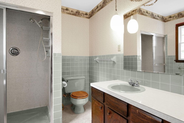2399 Arabelle Dr NE, Lancaster, OH 43130 - bathroom featuring wallpapered walls, a stall shower, vanity, a wainscoted wall, and tile walls