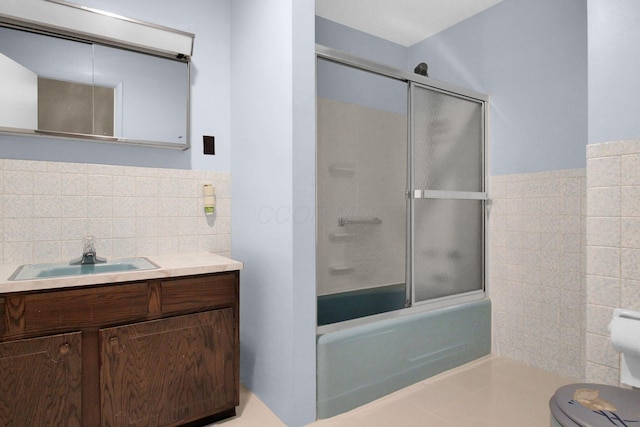 2399 Arabelle Dr NE, Lancaster, OH 43130 - bathroom with tile walls, vanity, enclosed tub / shower combo, a wainscoted wall, and tile patterned floors