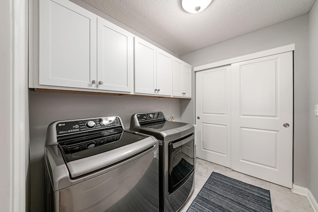 5540 Eva Loop S, Dublin, OH 43016 - laundry room featuring cabinet space, independent washer and dryer, and a textured ceiling