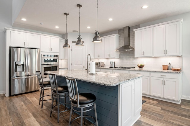5540 Eva Loop S, Dublin, OH 43016 - kitchen with appliances with stainless steel finishes, wall chimney range hood, white cabinets, decorative backsplash, and recessed lighting