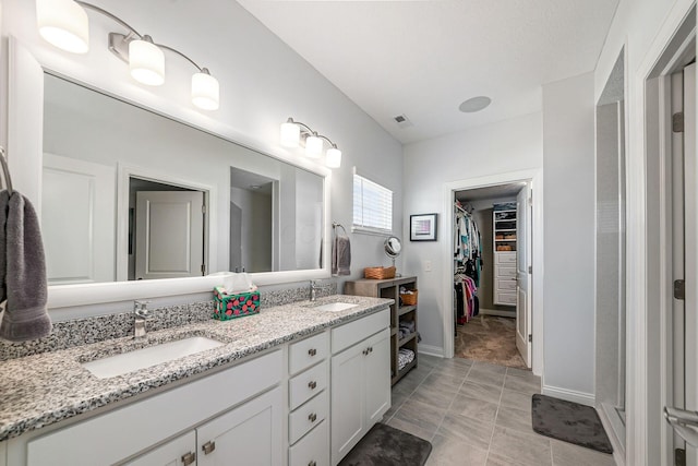 5540 Eva Loop S, Dublin, OH 43016 - full bath with double vanity, a spacious closet, and tile patterned flooring