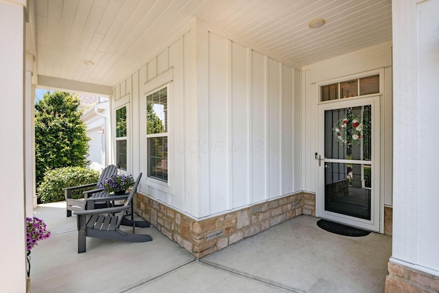 5540 Eva Loop S, Dublin, OH 43016 - view of exterior entry featuring a porch, board and batten siding, and stone siding
