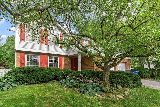 5500 Saddlebrook Dr, Columbus, OH 43221 - view of front of property with brick siding, an attached garage, and asphalt driveway