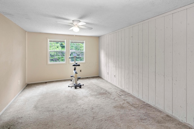 5500 Saddlebrook Dr, Columbus, OH 43221 - carpeted empty room with a ceiling fan, wooden walls, and a textured ceiling
