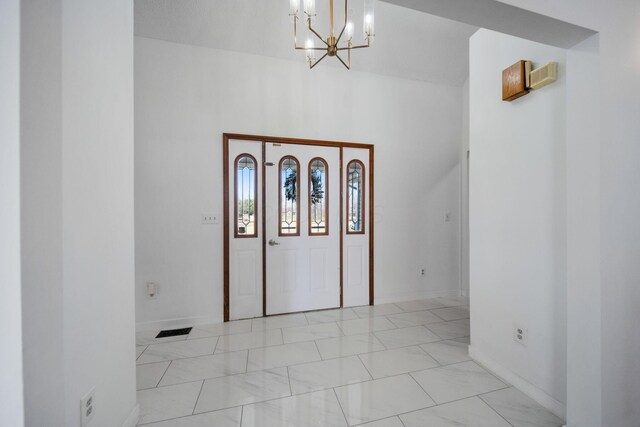 5583 Durrett Rd, Orient, OH 43146 - entrance foyer featuring a chandelier, light marble finish flooring, and a high ceiling