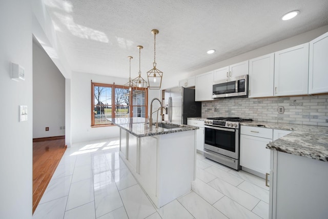 5583 Durrett Rd, Orient, OH 43146 - kitchen with appliances with stainless steel finishes, backsplash, light stone countertops, white cabinets, and recessed lighting