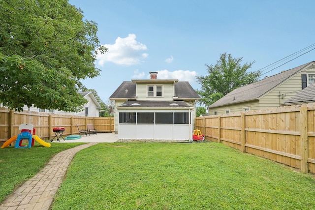 105 Marks Ave, Lancaster, OH 43130 - rear view of property featuring a sunroom, a patio area, a chimney, a fenced backyard, and a shingled roof