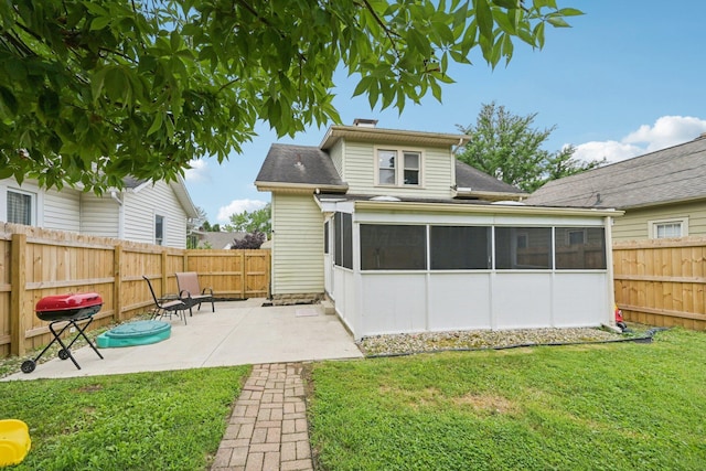 105 Marks Ave, Lancaster, OH 43130 - back of property featuring a sunroom, roof with shingles, and a patio