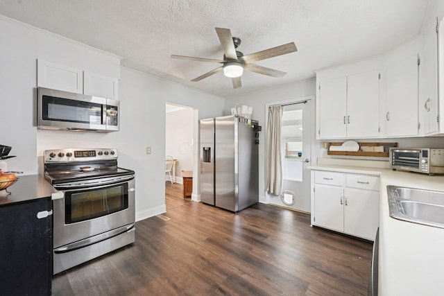 105 Marks Ave, Lancaster, OH 43130 - kitchen with stainless steel appliances, white cabinets, a ceiling fan, dark wood finished floors, and a textured ceiling