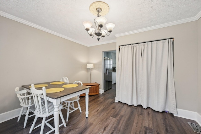 105 Marks Ave, Lancaster, OH 43130 - dining space featuring a chandelier, dark wood-type flooring, a textured ceiling, and crown molding