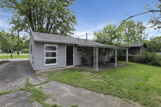 1535 S Hamilton Rd, Columbus, OH 43227 - back of house featuring a patio, a lawn, and roof with shingles