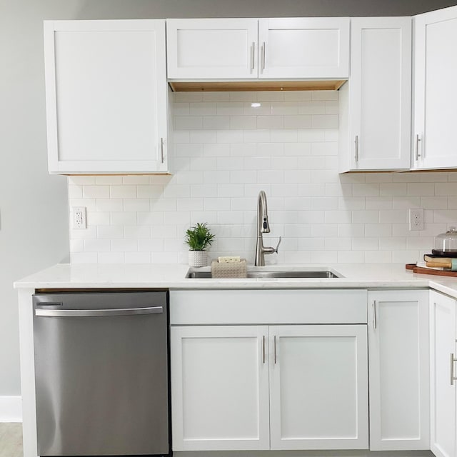 652 E 6th Ave, Lancaster, OH 43130 - kitchen with stainless steel dishwasher, decorative backsplash, white cabinets, and light countertops