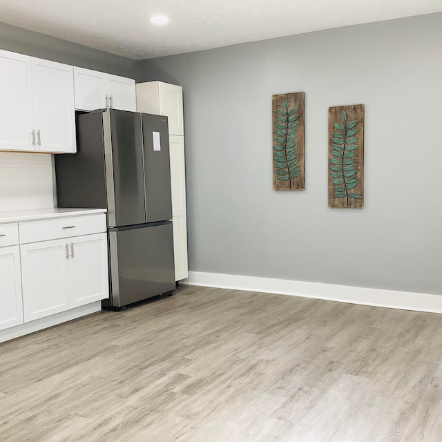652 E 6th Ave, Lancaster, OH 43130 - kitchen with light wood finished floors, freestanding refrigerator, white cabinets, and recessed lighting