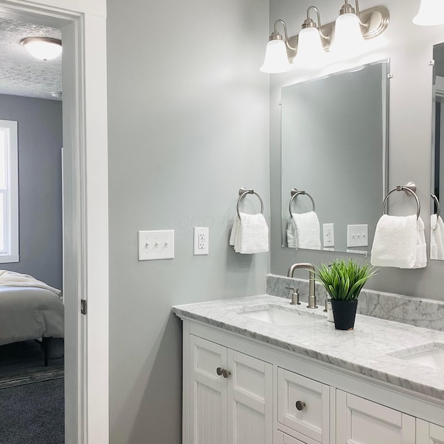 652 E 6th Ave, Lancaster, OH 43130 - ensuite bathroom with double vanity and a textured ceiling