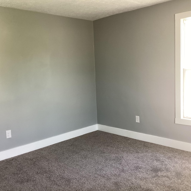 652 E 6th Ave, Lancaster, OH 43130 - unfurnished room with dark colored carpet and a textured ceiling