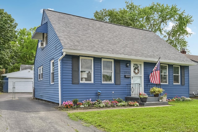 2931 Templeton Rd, Columbus, OH 43209 - view of front of home featuring a front lawn, roof with shingles, an outdoor structure, and a garage