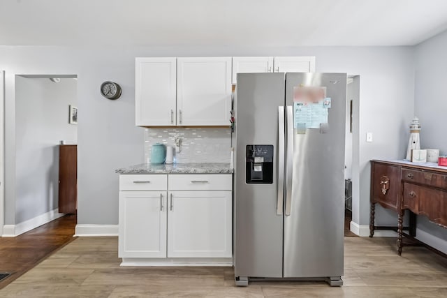 2931 Templeton Rd, Columbus, OH 43209 - kitchen featuring stainless steel fridge, white cabinets, light stone countertops, and light wood-style floors