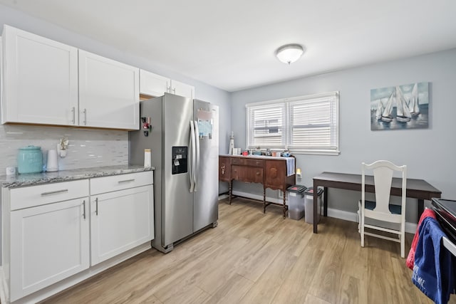 2931 Templeton Rd, Columbus, OH 43209 - kitchen with stainless steel refrigerator with ice dispenser, backsplash, light wood-type flooring, white cabinetry, and light stone counters
