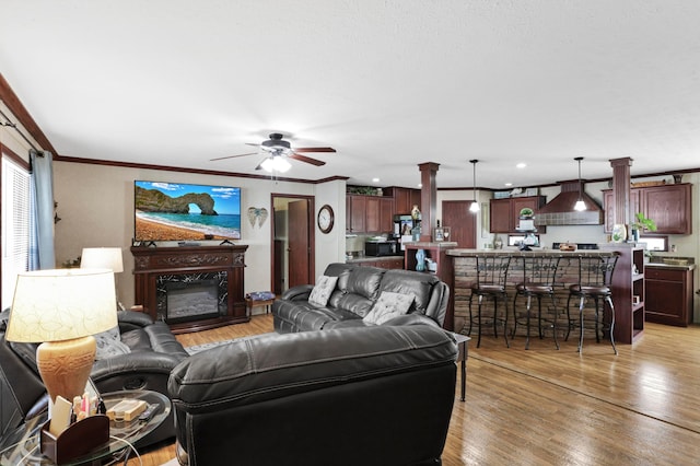 2445 Columbus-Lancaster Rd NW Unit 248Hickory, Lancaster, OH 43130 - living area with light wood finished floors, a ceiling fan, ornamental molding, a glass covered fireplace, and recessed lighting