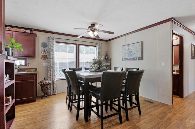2445 Columbus-Lancaster Rd NW Unit 248Hickory, Lancaster, OH 43130 - dining space with ornamental molding, a ceiling fan, light wood-type flooring, and a textured ceiling