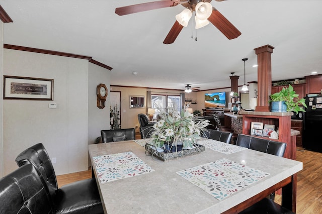 2445 Columbus-Lancaster Rd NW Unit 248Hickory, Lancaster, OH 43130 - dining area with a ceiling fan, ornate columns, light wood finished floors, and crown molding