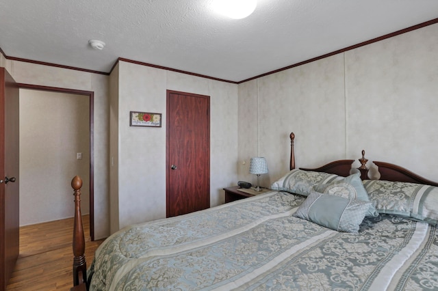 2445 Columbus-Lancaster Rd NW Unit 248Hickory, Lancaster, OH 43130 - bedroom featuring wood finished floors, a closet, ornamental molding, and a textured ceiling