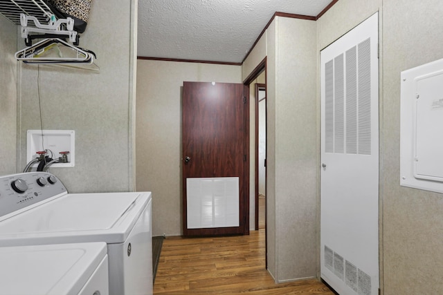 2445 Columbus-Lancaster Rd NW Unit 248Hickory, Lancaster, OH 43130 - laundry room featuring wood finished floors, washer and dryer, a heating unit, ornamental molding, and a textured ceiling