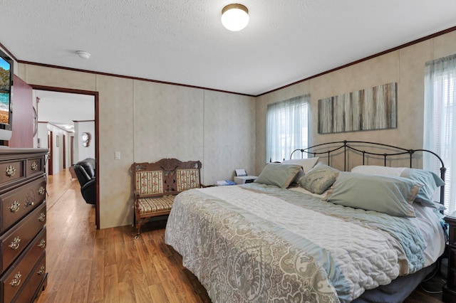 2445 Columbus-Lancaster Rd NW Unit 248Hickory, Lancaster, OH 43130 - bedroom with wood finished floors, multiple windows, crown molding, and a textured ceiling