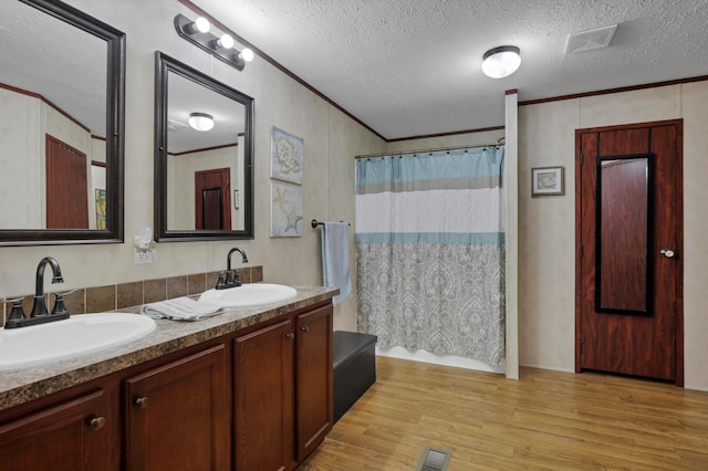 2445 Columbus-Lancaster Rd NW Unit 248Hickory, Lancaster, OH 43130 - full bath featuring double vanity, wood finished floors, a textured ceiling, and crown molding