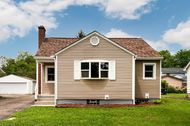 205 N Gould Rd, Columbus, OH 43209 - view of front of house with a detached garage, an outdoor structure, a shingled roof, and a front lawn