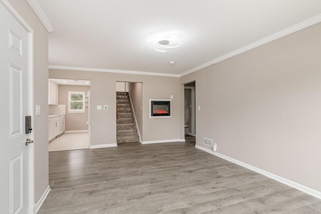 205 N Gould Rd, Columbus, OH 43209 - spare room featuring stairs, light wood-style flooring, and crown molding