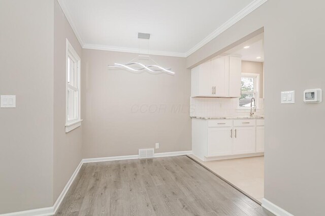 205 N Gould Rd, Columbus, OH 43209 - unfurnished dining area with light wood-style floors, a chandelier, and ornamental molding