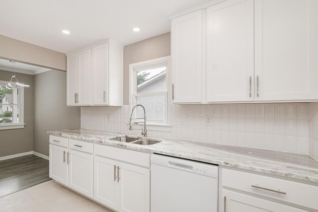 205 N Gould Rd, Columbus, OH 43209 - kitchen with white dishwasher, white cabinetry, plenty of natural light, light stone counters, and ornamental molding