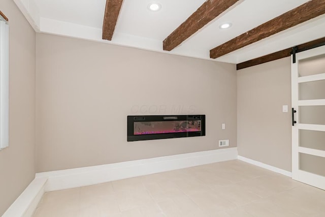 205 N Gould Rd, Columbus, OH 43209 - below grade area with recessed lighting, a barn door, a glass covered fireplace, and tile patterned floors