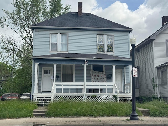 1345 E Livingston Ave Unit 1347, Columbus, OH 43205 - american foursquare style home featuring covered porch, a chimney, and a shingled roof