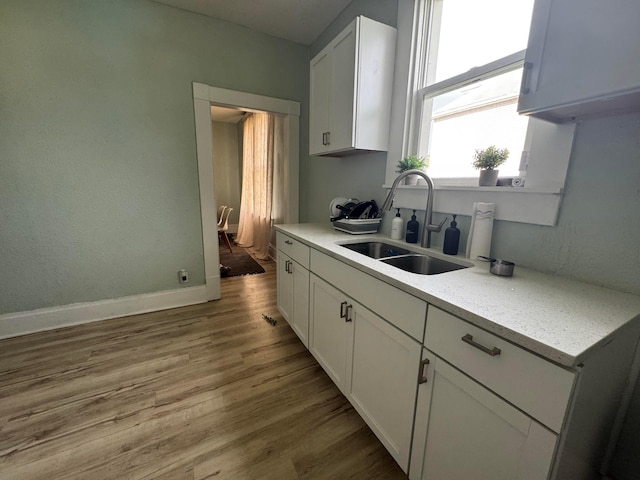 1345 E Livingston Ave Unit 1347, Columbus, OH 43205 - kitchen with white cabinetry, wood finished floors, and light stone counters