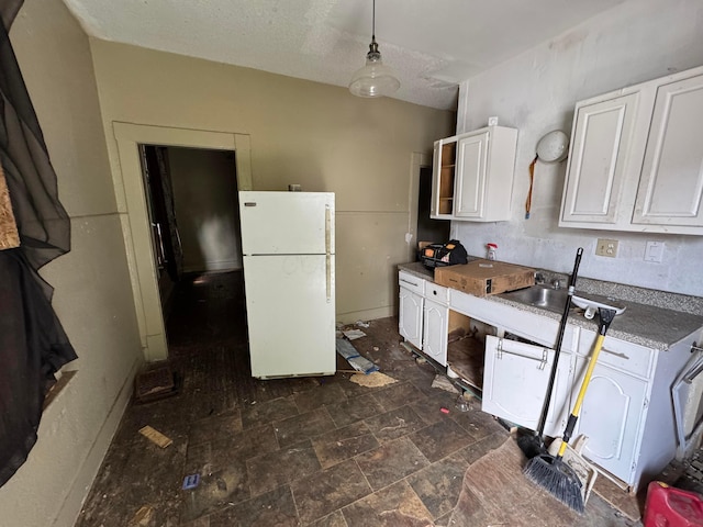 1345 E Livingston Ave Unit 1347, Columbus, OH 43205 - kitchen with freestanding refrigerator, white cabinets, and hanging light fixtures