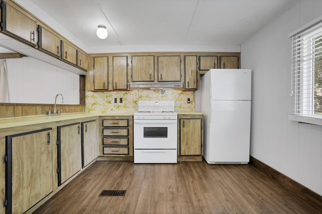 19 E 1st St, The Plains, OH 45780 - kitchen featuring white appliances, under cabinet range hood, light countertops, dark wood finished floors, and brown cabinetry