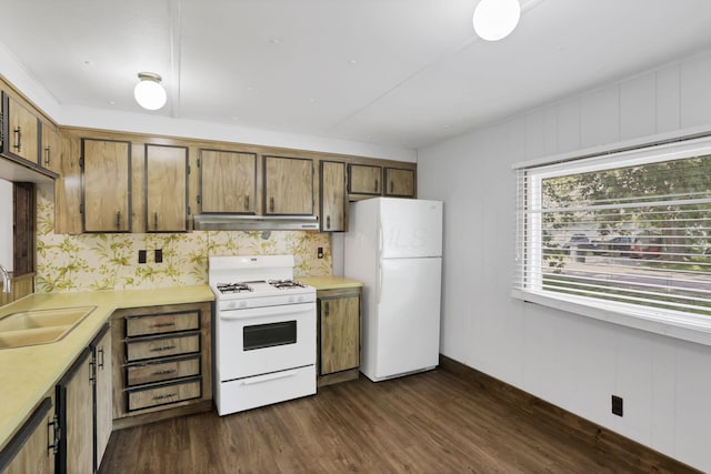 19 E 1st St, The Plains, OH 45780 - kitchen with white appliances, under cabinet range hood, light countertops, dark wood-style floors, and brown cabinetry