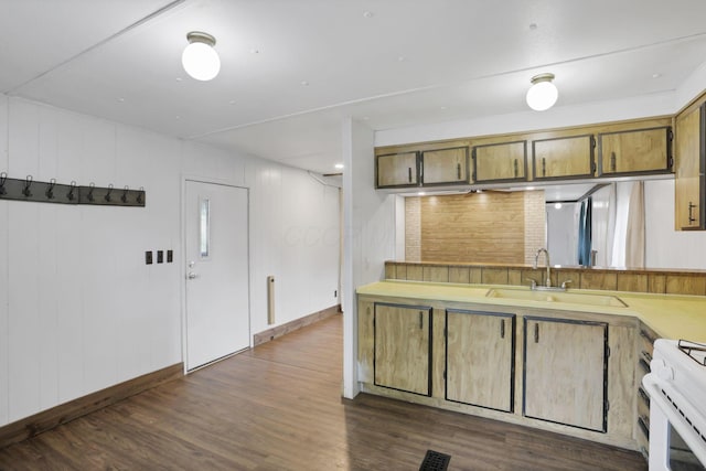 19 E 1st St, The Plains, OH 45780 - kitchen with dark wood-type flooring, white gas range, brown cabinets, and light countertops