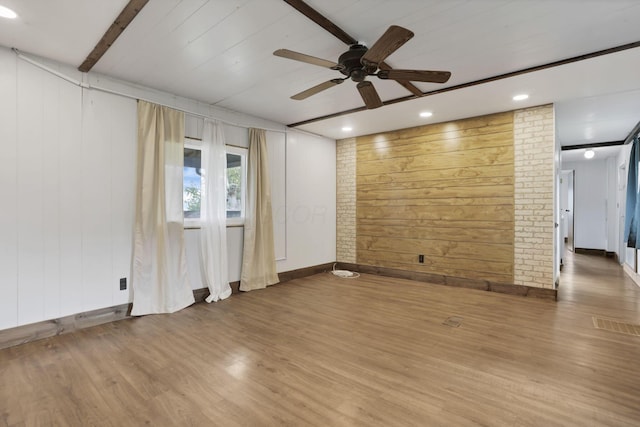 19 E 1st St, The Plains, OH 45780 - unfurnished living room with a ceiling fan, wooden walls, and wood finished floors