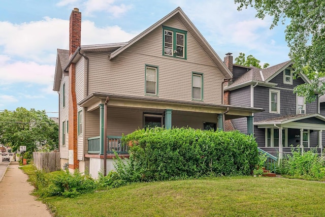 2521 Glenmawr Ave, Columbus, OH 43202 - view of front of property featuring a chimney, covered porch, and a front yard