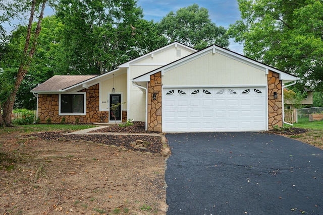 260 Old Coach Pl, Canal Winchester, OH 43110 - view of front of house featuring stone siding, driveway, an attached garage, and a shingled roof
