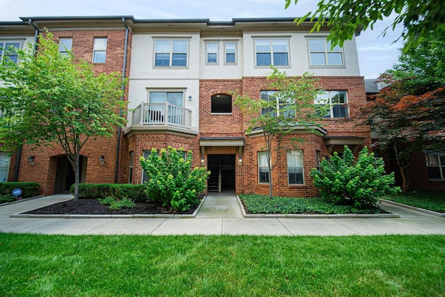29 Victorian Gate Way, Columbus, OH 43215 - view of property with brick siding, a balcony, and stucco siding