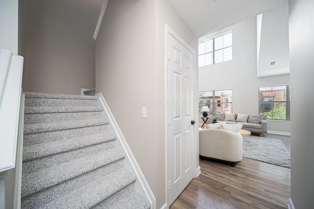 29 Victorian Gate Way, Columbus, OH 43215 - stairs featuring wood finished floors, healthy amount of natural light, and a high ceiling