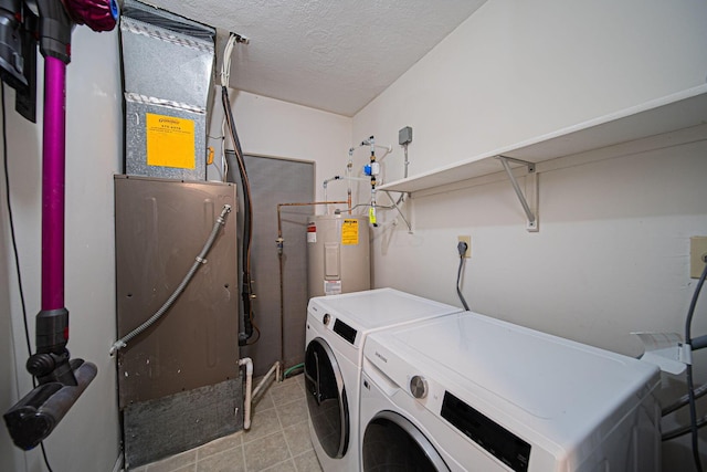 29 Victorian Gate Way, Columbus, OH 43215 - washroom with washer and dryer, electric water heater, light tile patterned floors, a textured ceiling, and heating unit